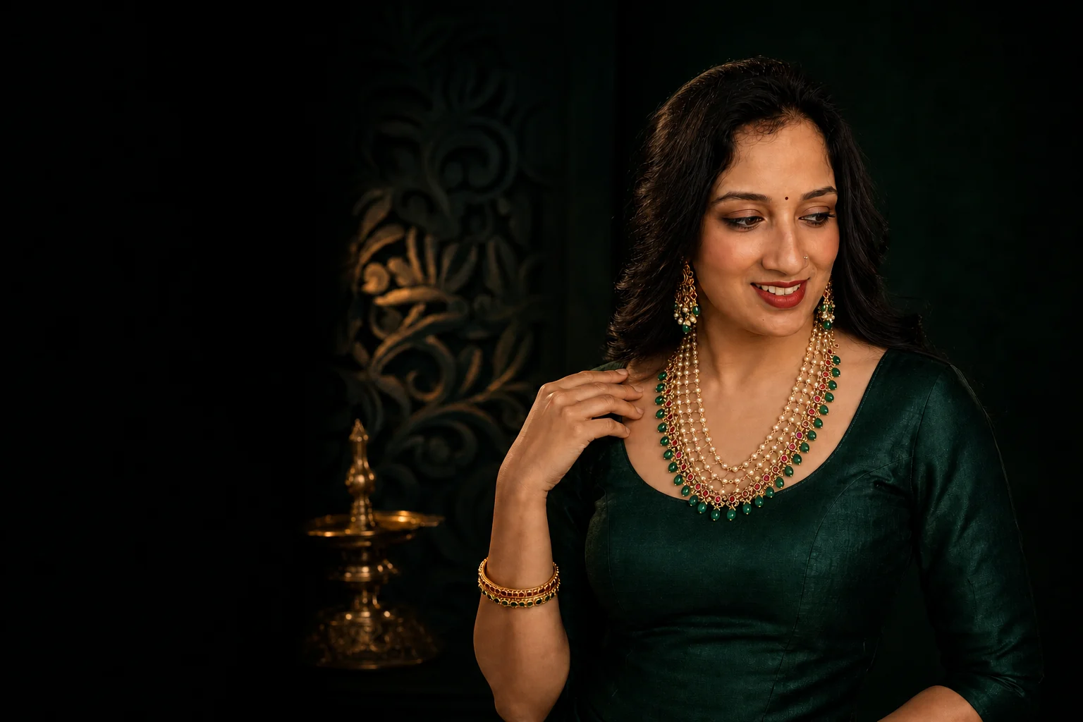 Alankara model wearing a layered pearl, red and green occasion necklace set