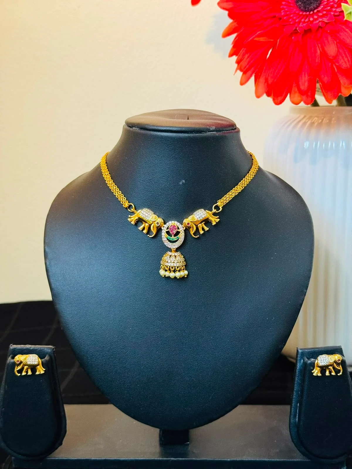 Latest Alankara elephant-motif necklace with a central pearl-drop pendant and matching earrings