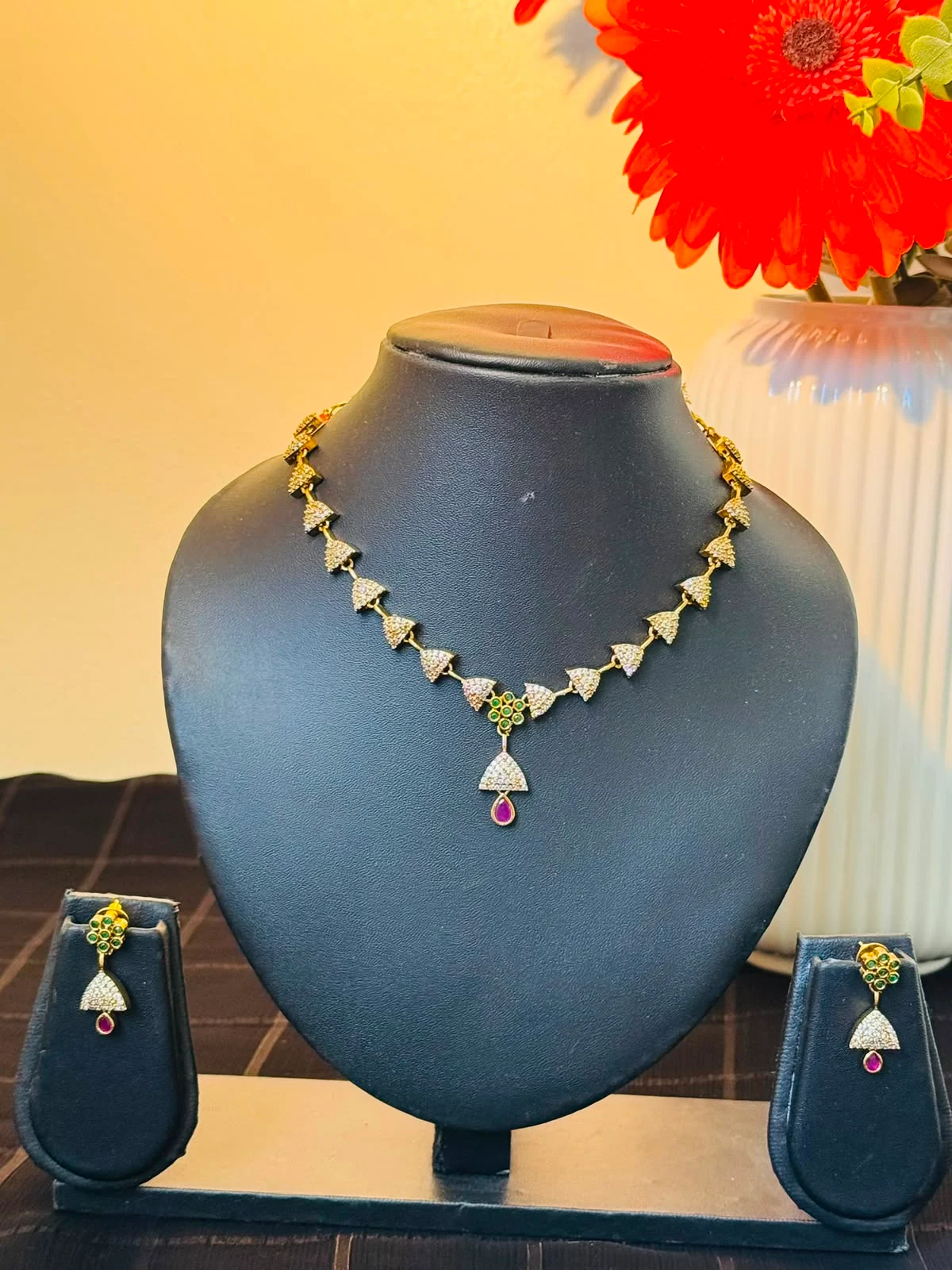 Latest Alankara geometric crystal necklace with ruby drop pendant and matching earrings