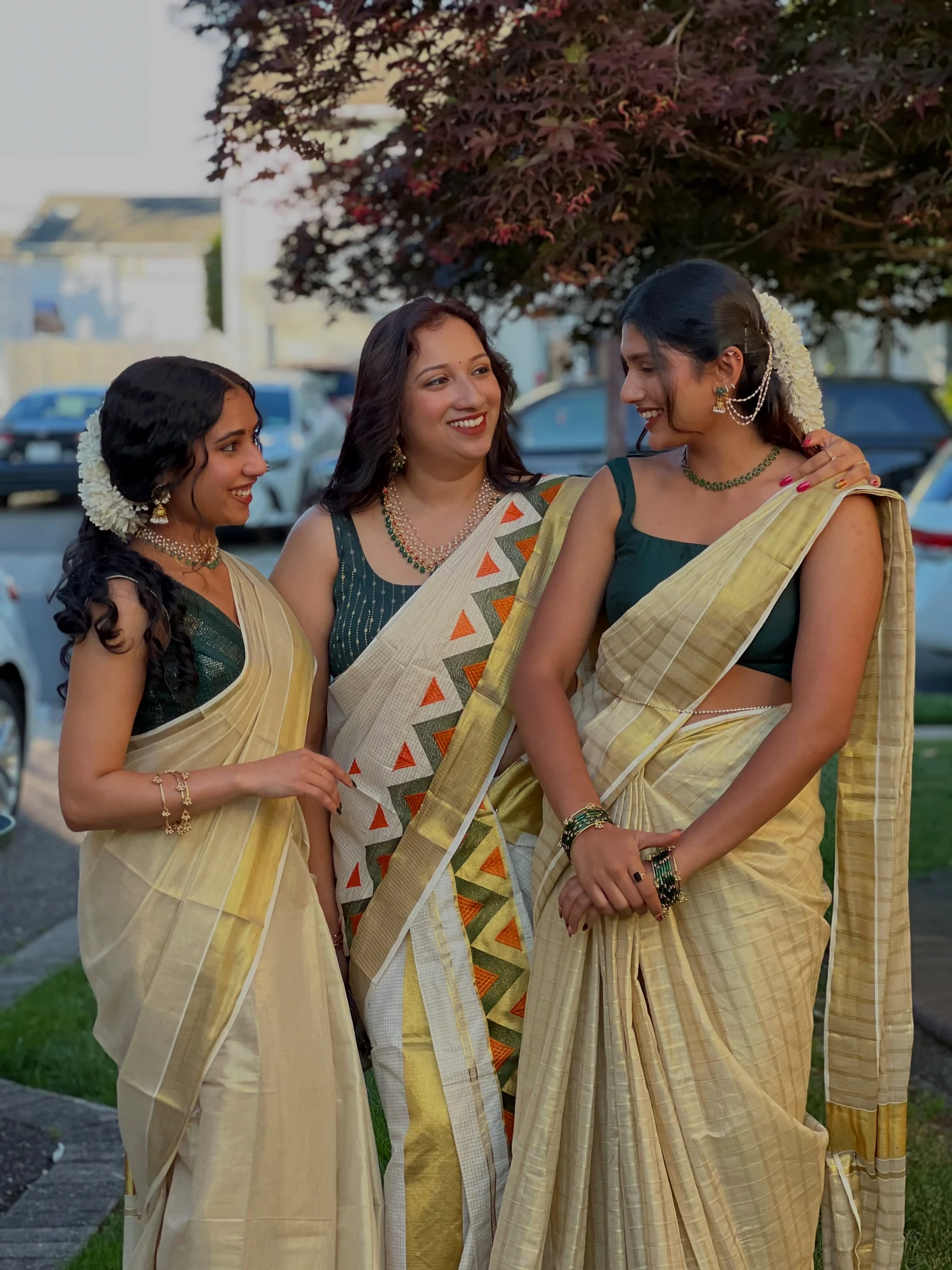 Three Alankara models wearing coordinated occasion necklaces, earrings and bangles